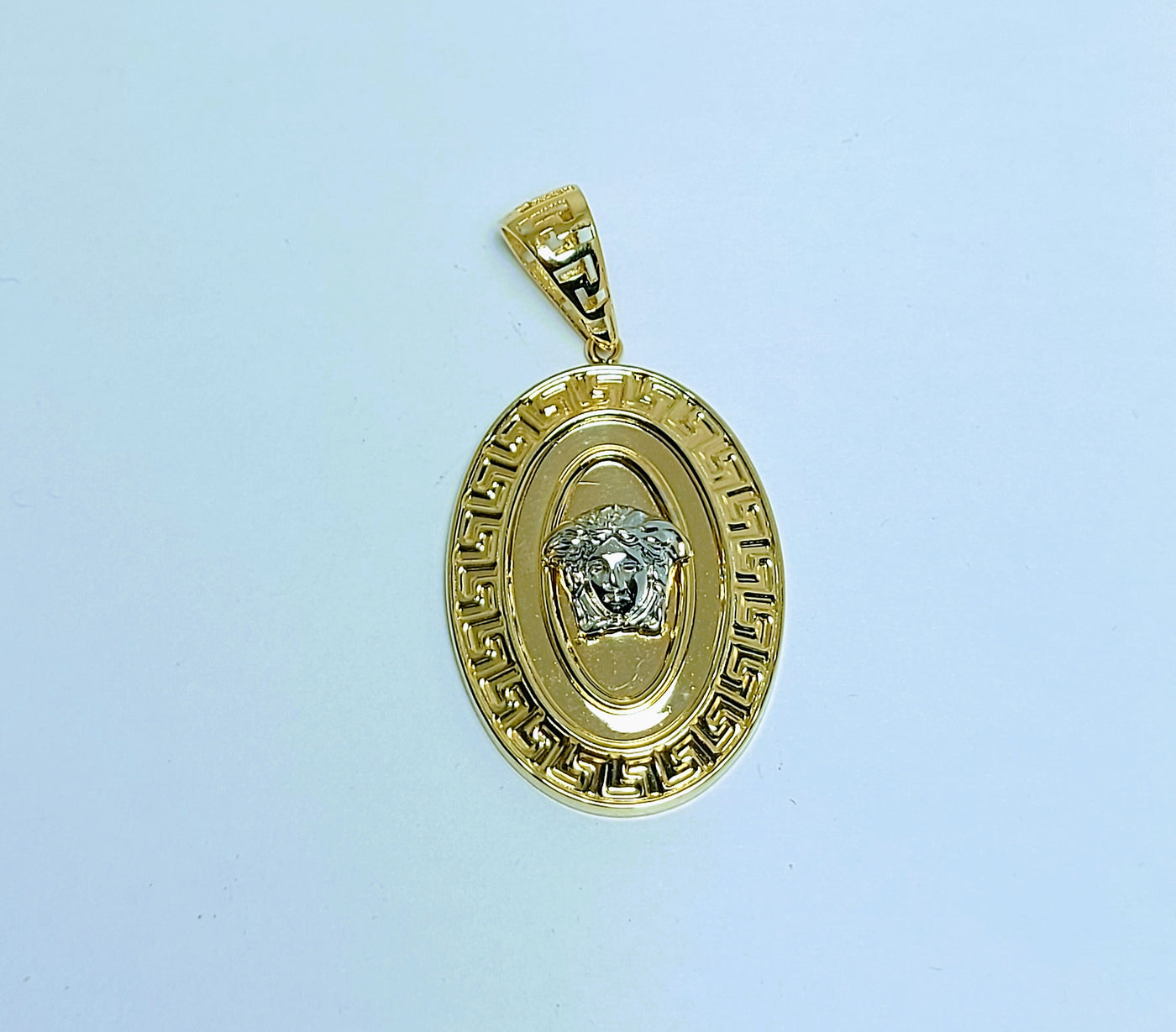 Oval shaped Versace head gold pendant