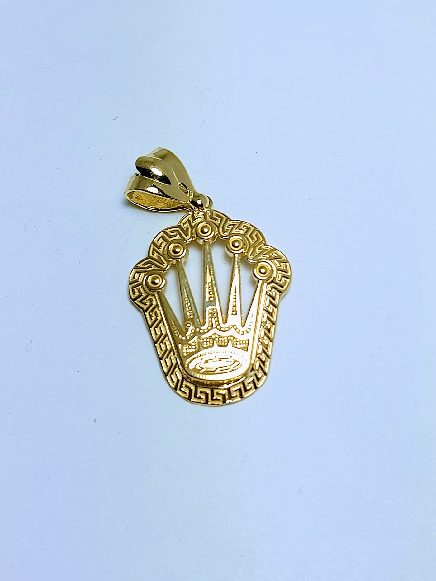 Gold king crown with Greek design around pendant